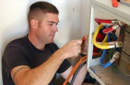 this is an electrical contractor working on a wiring box with many different colored wires